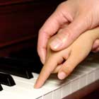 child enjoying private piano lesson in home