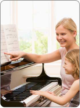child enjoying advanced private piano lesson
